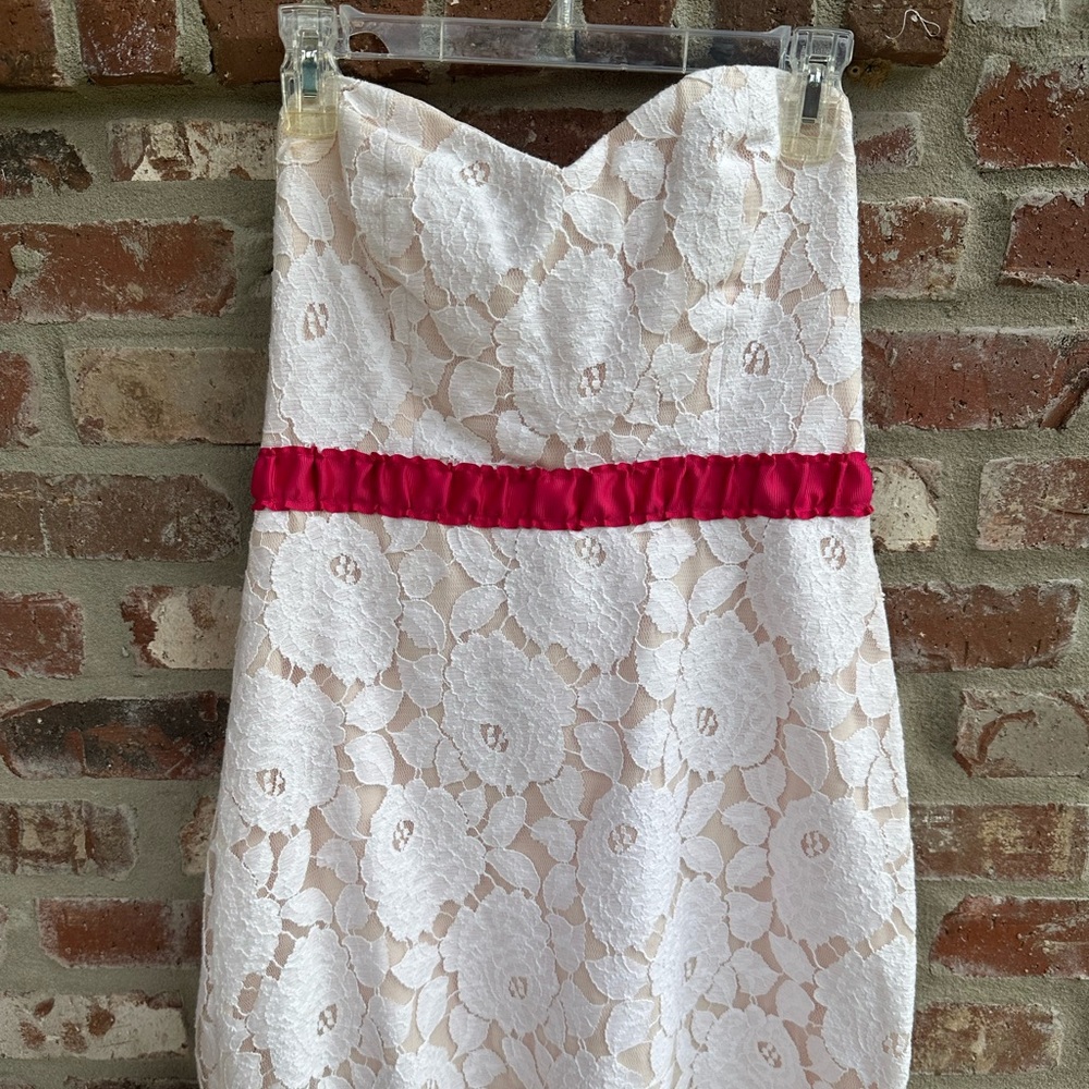 Ivory and pink cream lace dress with pink detail. Boutique Rubber Ducky brand.